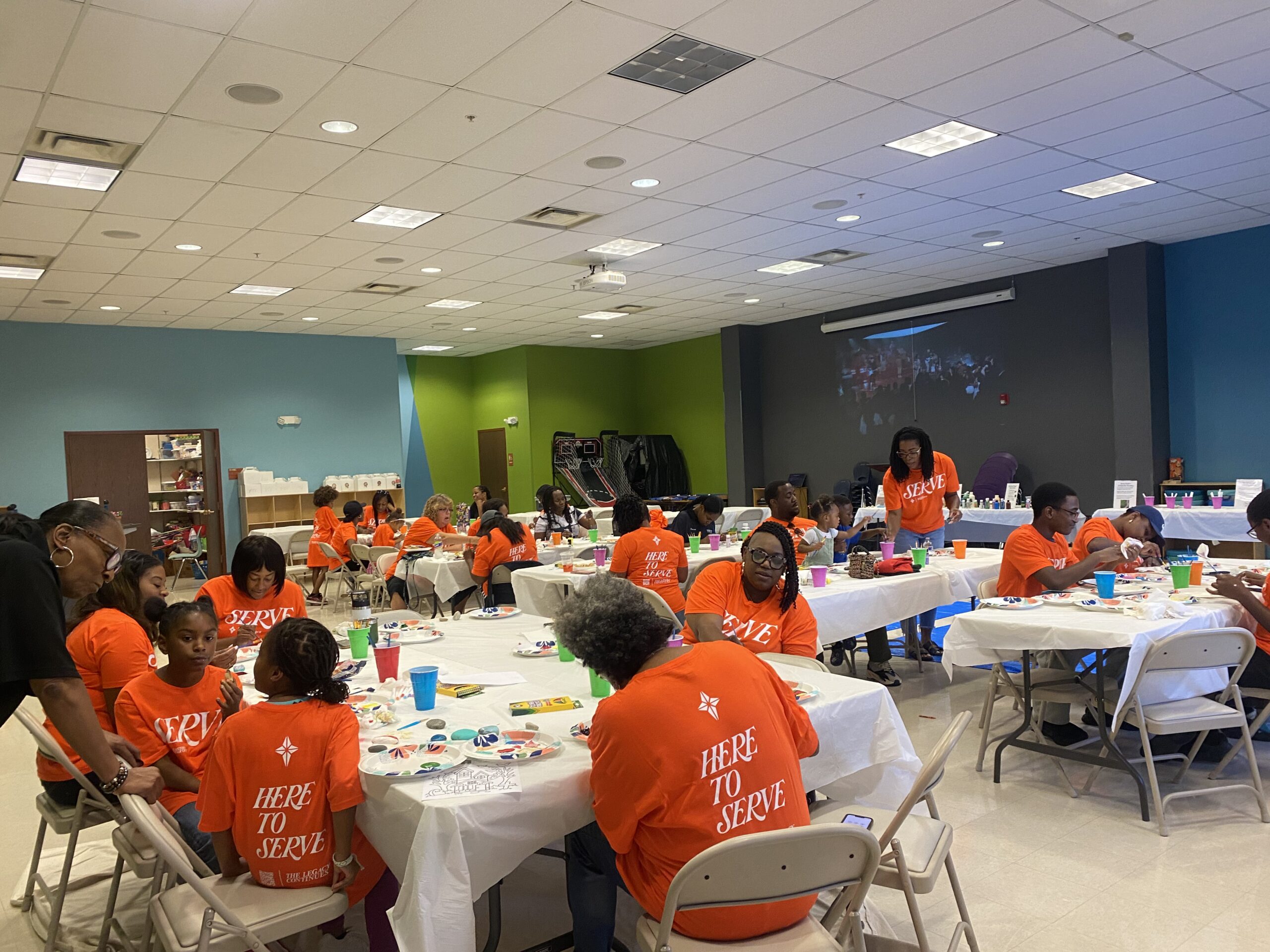 Community members painting rocks